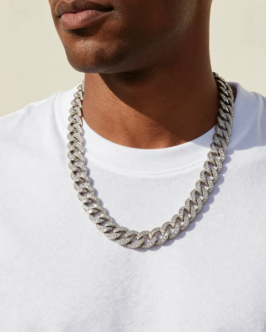 Man wearing an iced cuban link chain over a white tee